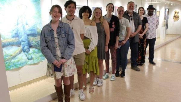 9 people standing in front of ArtSpace Gallery